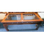 MAHOGANY COFFEE TABLE WITH CARVED DECORATION AND TWIN GLASS PANEL INSERT TOPS - 121 X 61 CM