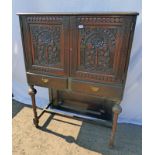 19TH CENTURY CARVED OAK CABINET ON STAND WITH 2 CARVED PANEL DOORS OVER 2 DRAWERS ON TURNED