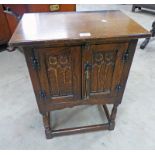 20TH CENTURY OAK HALL CABINET WITH 2 PANEL DOORS AND CARVED DECORATION ON TURNED SQUARE SUPPORTS