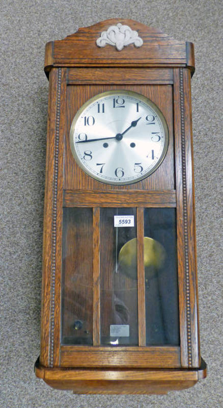 EARLY 20TH CENTURY OAK WALL CLOCK WITH GLASS PANEL DOOR