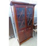 LATE 20TH CENTURY MAHOGANY BOOKCASE WITH 2 ASTRAGAL GLAZED DOORS OVER 2 DRAWERS & 2 PANEL DOORS ON