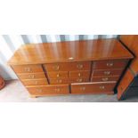 MULTI DRAWER CHEST WITH 3 CENTRALLY SET DRAWERS FLANKED BY 2 DRAWERS TO EACH SIDE OVER 2 LONG