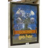 FRAMED HARRY POTTER POSTER WITH CAST SIGNATURES INCLUDING WARWICK DAVIS AND OTHERS.