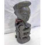 CARVED WOODEN CENTRAL AFRICAN FIGURE WITH ORNATE HAIR, SEATED FEEDING TWINS 29CM TALL,