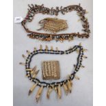 AFRICAN TRIBAL NECKLACES MADE UP OF LARGE ANIMAL TEETH AND BEADS,