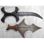 TRIBAL KNIFE WITH 22 CM LONG CURVED DOUBLE EDGED BLADE WITH A X - SHAPED CARED WOODEN HANDLE AND A