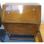 20TH CENTURY OAK BUREAU ON TURNED SUPPORTS