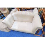 2 SEATER OVERSTUFFED SETTEE ON TURNED SUPPORTS,