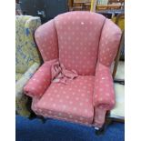 RED OVERSTUFFED WINGBACK ARMCHAIR ON SHAPED SUPPORTS