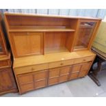 TEAK 1970'S STYLE CABINET WITH SHELVED CENTRALLY SET SECTION FLANKED BY GLASS PANEL DOOR & FALL
