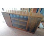 20TH CENTURY TEAK BOOKCASE WITH SLIDING GLASS DOOR FLANKED BY PANEL DOORS,