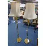 2 BRASS STANDARD LAMPS ON CIRCULAR BASES.