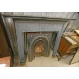 PAINTED BLACK CAST IRON FIRE SURROUND WITH WREATH DECORATION, 136CM TALL X 158CM WIDE,