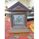 LATE 19TH CENTURY OAK MANTLE CLOCK WITH BRASS & SILVERED DIAL ON BRACKET SUPPORTS - 38CM TALL