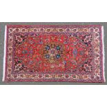 OLD RED GROUND IRANIAN RUG WITH FLORAL MEDALLION DESIGN 219 X 130CM