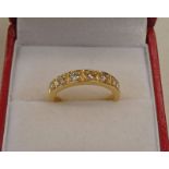 DIAMOND SET 7 STONE RING IN SETTING MARKED 18CT Condition Report: Ring size: L.