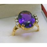 GOLD OVAL AMETHYST AND DIAMOND SET RING Condition Report: Ring size: N.