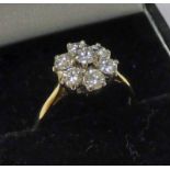 18 CT GOLD DIAMOND SET CLUSTER RING. THE 7 BRILLIANT CUT DIAMONDS OF APPROX 1.