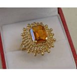 CITRINE SET RING IN DECORATIVE SETTING MARKED 18K