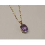 9CT GOLD OVAL AMETHYST PENDANT ON 9CT GOLD CHAIN