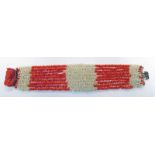 19TH / EARLY 20TH CENTURY 9 - STRAW RED & WHITE CORAL BRACELET WITH A CORAL CAMEO MOUNTED ON A