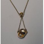 CULTURED PEARL SET SHELL PENDANT MARKED 9CT ON FINE CHAIN