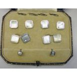 CASED SET OF CUFF LINKS AND STUDS WITH MOTHER OF PEARL DECORATION AND MARKED 9CT
