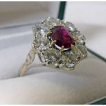 RUBY & DIAMOND CLUSTER RING. THE OVAL RUBY IN A SURROUND OF 8 BRILLIANT CUT DIAMONDS OF APPROX 2.