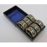 CASED SET OF 6 EARLY 20TH CENTURY SILVER NAPKIN RINGS WITH DECORATIVE GRANITE PANELS & FOLIATE