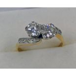18CT GOLD & PLATINUM 2-STONE DIAMOND TWIST RING WITH DIAMOND SET SHOULDERS,