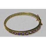 9CT GOLD AMETHYST BANGLE SET WITH 11 CIRCULAR GRADUATED AMETHYSTS Condition Report: