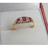18CT GOLD RUBY AND DIAMOND SET RING,
