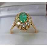 EMERALD & DIAMOND SET CLUSTER RING IN SETTING MARKED 15 CT .