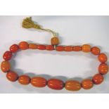 STRING OF ARTS & CRAFTS STYLE AMBER COLOURED BEADS Condition Report: The beads have