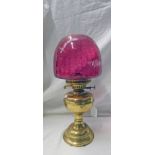 BRASS OIL LAMP WITH RED GLASS SHADE - 42 CM TALL EXCLUDING FUNNEL