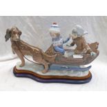 LLADRO PORCELAIN FIGURE SET OF A DOG PULLING A BOY & GIRL IN A SLEDGE .