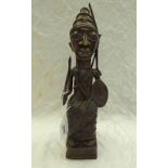 AFRICAN BRONZE FIGURE OF SEATED MAN WITH AXE & SHIELD - 35CM TALL