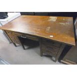 OAK KNEEHOLE DESK WITH CENTRALLY SET DRAWER FLANKED BY 3 DRAWERS TO EITHER SIDE