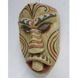 AFRICAN PAINTED WOODEN MASK, THE MOUTH WITH LARGE SINGLE TOOTH PAINTED TRIBAL SCARS, 30.