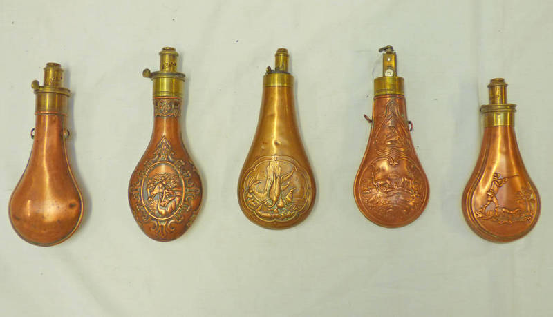 FIVE REPRODUCTION POWDER FLASKS Condition Report: All bar the flask with horses