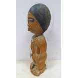 AFRICAN MALE STANDING FIGURE WITH SIMPLE COIFFURE HOLDING A VESSEL,