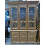 OAK CABINET WITH 2 GLASS PANEL DOORS OPENING TO SHELVED INTERIOR OVER 3 PANEL DOORS,