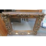 ORNATE GILT FRAMED MIRROR WITH BEVELLED EDGE 96CM X 126CM Condition Report: Resin.