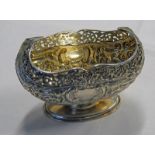 SILVER OVAL BOWL WITH PIERCED BORDER & FLORAL EMBOSSED DECORATION ON A PEDESTAL BASE,