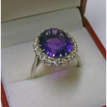 AN AMETHYST AND DIAMOND CLUSTER RING,