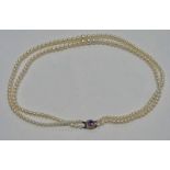 GRADUATED CULTURED PEARL DOUBLE STRAND NECKLACE ON A 9CT GOLD AMETHYST SET CLASP