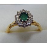 18CT GOLD EMERALD AND DIAMOND SET CLUSTER RING Condition Report: Ring size: R.