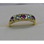 18CT GOLD RUBY & DIAMOND 5-STONE RING IN A SCROLL MOUNT Condition Report: Ring size: