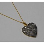DIAMOND SET HEART SHAPED PENDANT ON AN 18CT GOLD CHAIN Condition Report: The