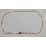 CULTURED PEARL SINGLE STRAND NECKLACE WITH A 9CT GOLD PEARL & GARNET CLUSTER CLASP.